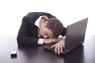 Business man sleeping over laptop clipart