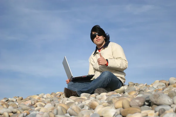 Випадковий чоловік з ноутбуком на пляжі — стокове фото