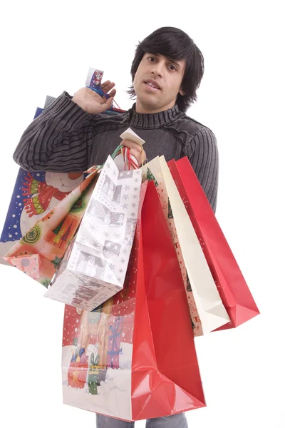 stock image Young man full of Christmas gifts