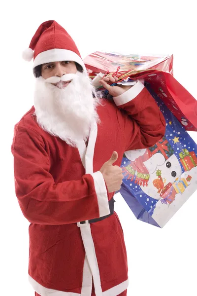 Junger Weihnachtsmann, voller Geschenke — Stockfoto