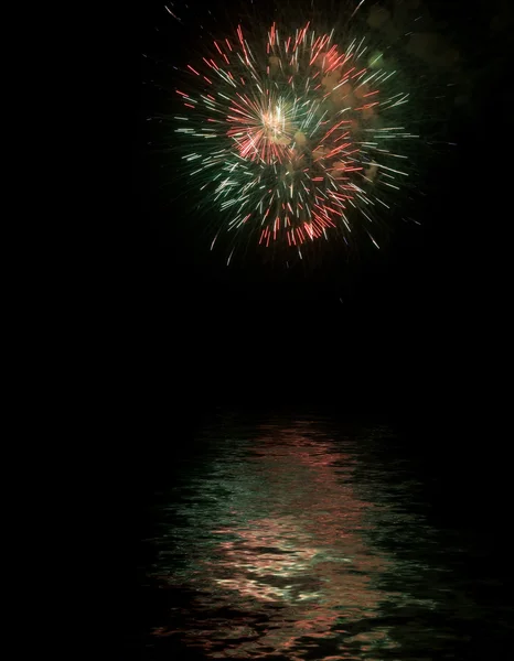 Fireworks with reflexes on water — Stock Photo, Image