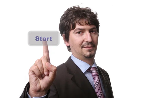 Young business man presses button — Stock Photo, Image