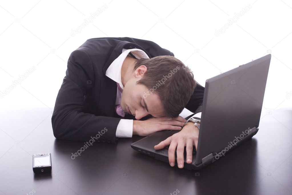 Business man sleeping over laptop