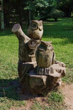 Wooden sculpture of an owl in the Park clipart