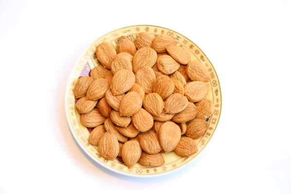 Plate with almonds — Zdjęcie stockowe
