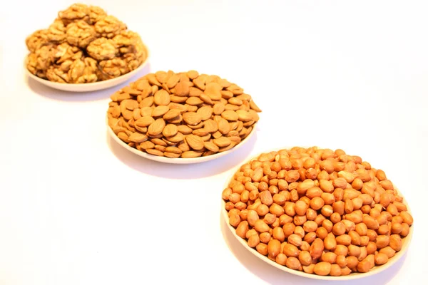 Three plates with different nuts — Stock Photo, Image