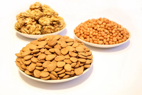 Three plates with different nuts — Stock Photo, Image