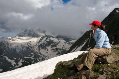 Hiker girl in hight mountains clipart