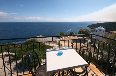 Balcony over sea and old white windmill clipart