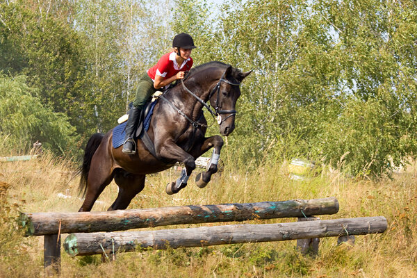 Girl on jumping horse