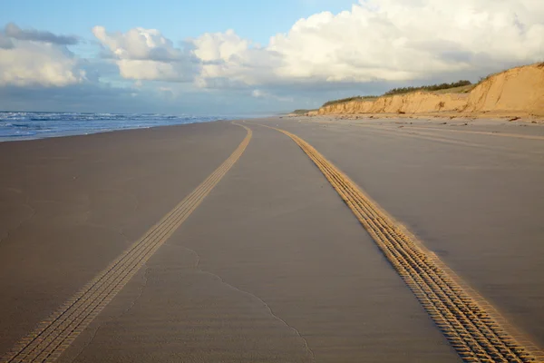 Impressão de rodas de carro em uma praia oceânica — Fotografia de Stock