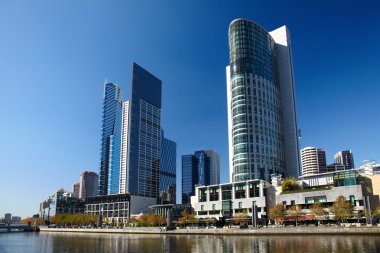 Modern buildings at river bank clipart