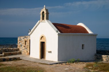 Old white church on sea coast clipart