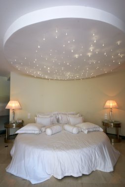 Ceiling like a stars sky over double bed clipart