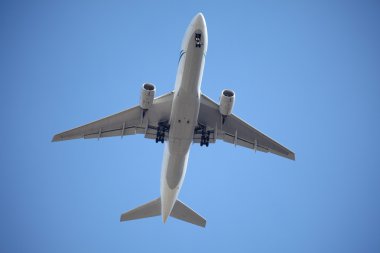 Airplane in blue sky clipart