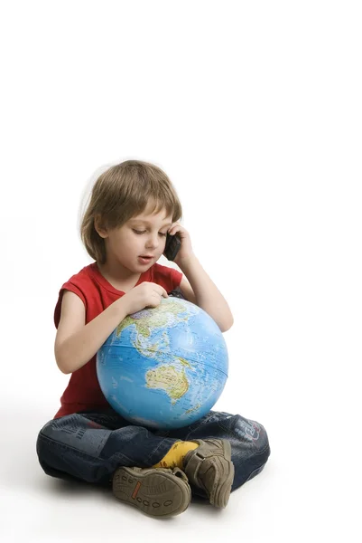 stock image Little boy with a mobile phone and globe