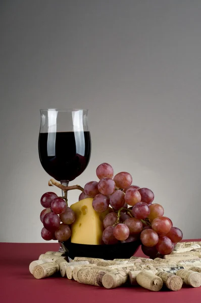 Red wine glass witn cheese and grape. — Stock Photo, Image