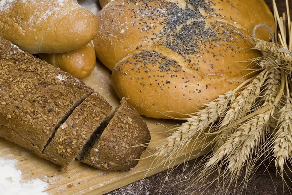 Close-up with bread, flour and cereals. — Stock Photo, Image