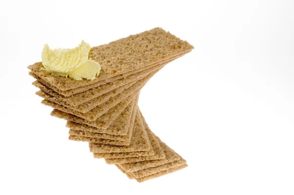 Dieet crackers met boter over Wit. — Stockfoto