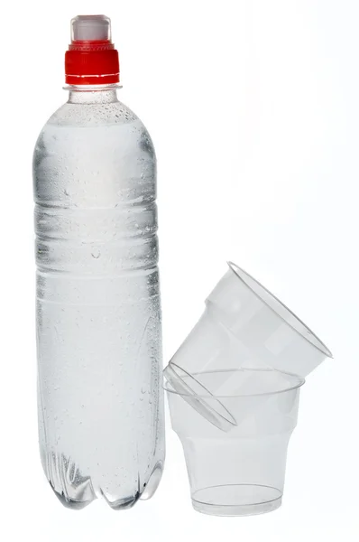 Soda water bottle with plastic glass — Stock Photo, Image