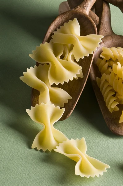 Dried pasta in wood spoon — Stockfoto