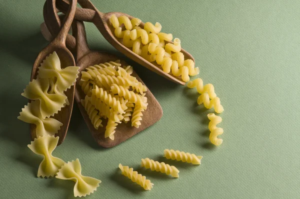 Dried pasta in wood spoon — Stock Photo, Image
