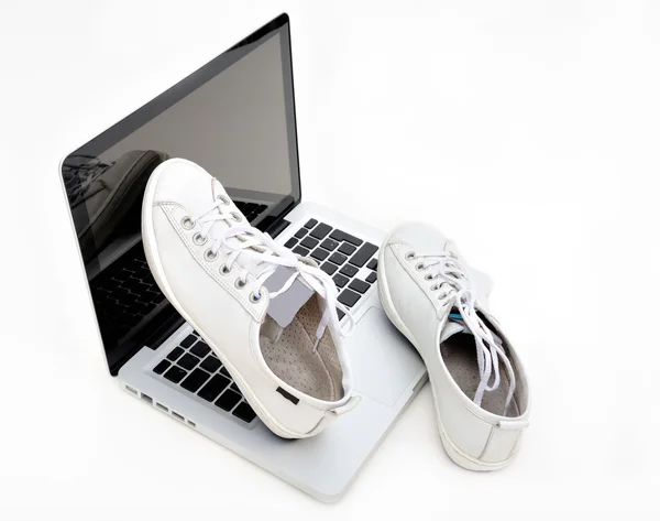 Спортивная обувь на ноутбуке — стоковое фото