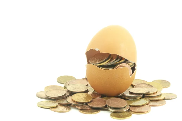 Coins in a egg shell — Stock Photo, Image