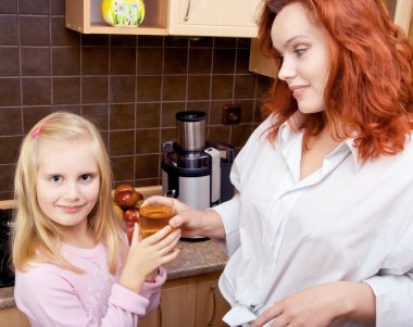 Mother standing in the kitchen clipart