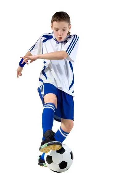 Αγόρι ένα ποδοσφαιριστής ξυλοδαρμό σε μια σφαίρα Royalty Free Εικόνες Αρχείου
