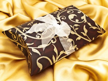 Gift at golden fabric clipart