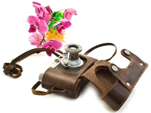 Photocamera and pink orchid — Stock Photo, Image