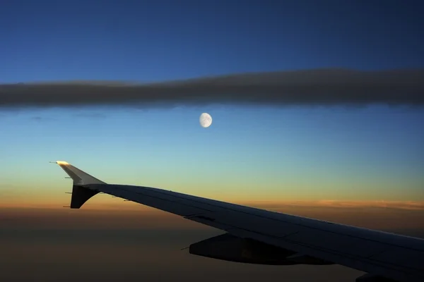 Airplane wing and moon