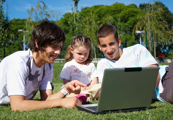 Two guys and a little girl in the park — Stock Photo, Image