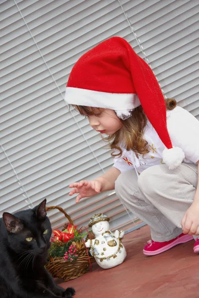 Little girl and black cat — Stock Photo, Image