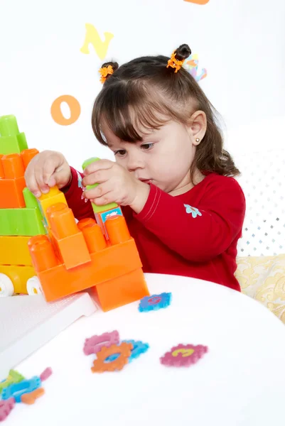 Menina joga um cubos coloridos — Fotografia de Stock