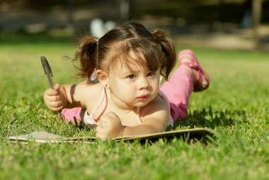 Girl paints in a park clipart