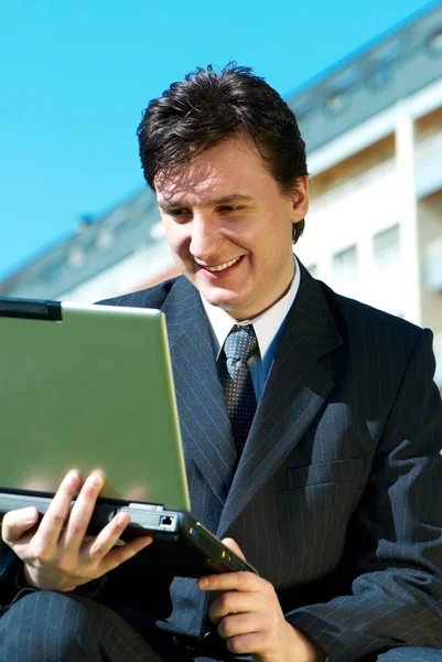Young man with a computer — Stock Photo, Image