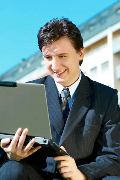 Young man with a computer — Stock Photo, Image