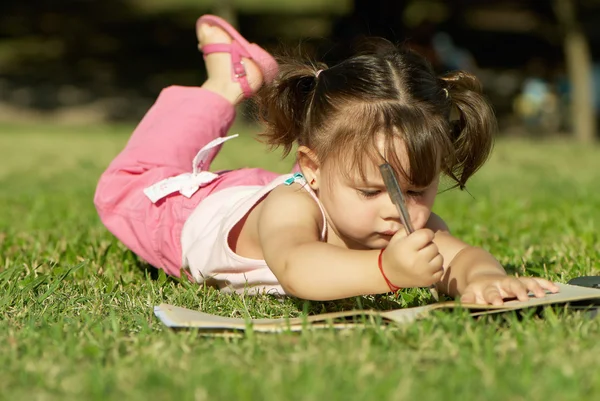 草に敷設小さな女の子 — ストック写真