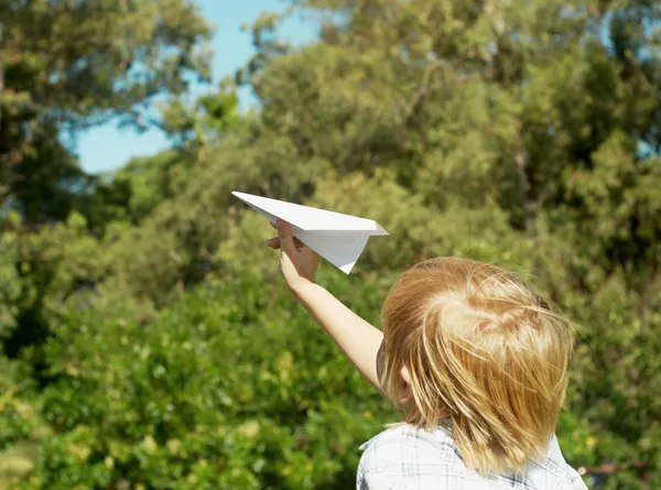 Boy launch paper airplane — Stock Photo, Image