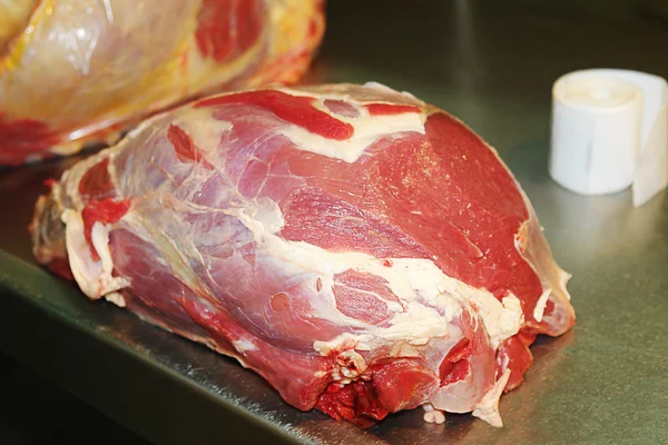Hovězí maso nakrájíme na pracovním stole — Stock fotografie