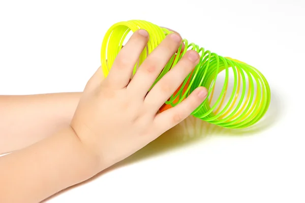 Spring toy in the hands of a child — Stock Photo, Image