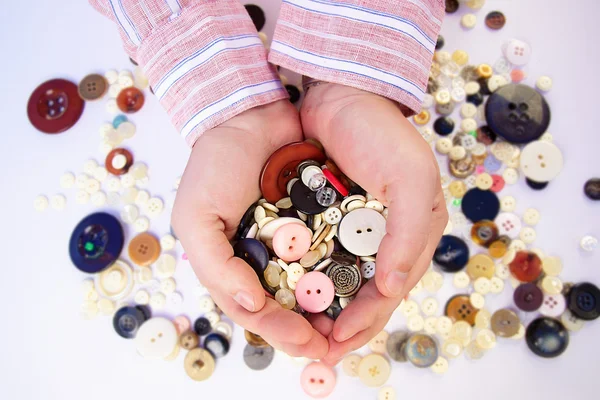 Buttons for sewing in the hands — Stock Photo, Image
