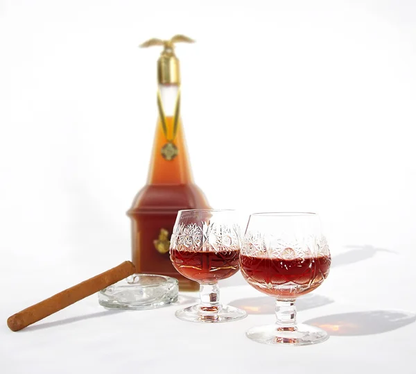 Two glasses of cognac on the background of the bottle — Stock Photo, Image