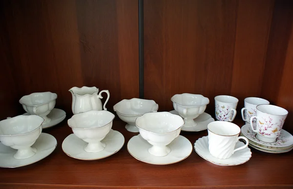 Cups in cupboard — Stock Photo, Image