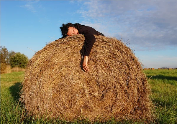 stock image Man lies on the haystack