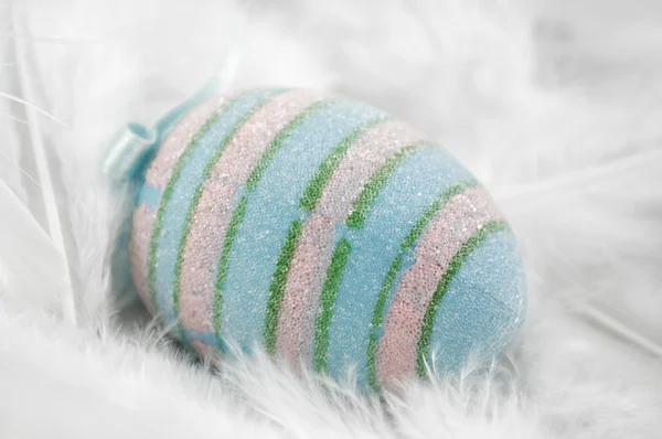 stock image Easter agg on white feathers