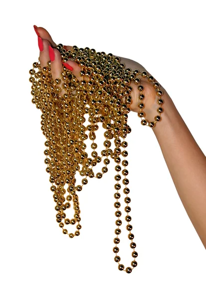 Zlaté korálky v ženské ruce — Stock fotografie