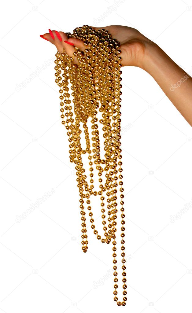 Female hand hold gold beads.